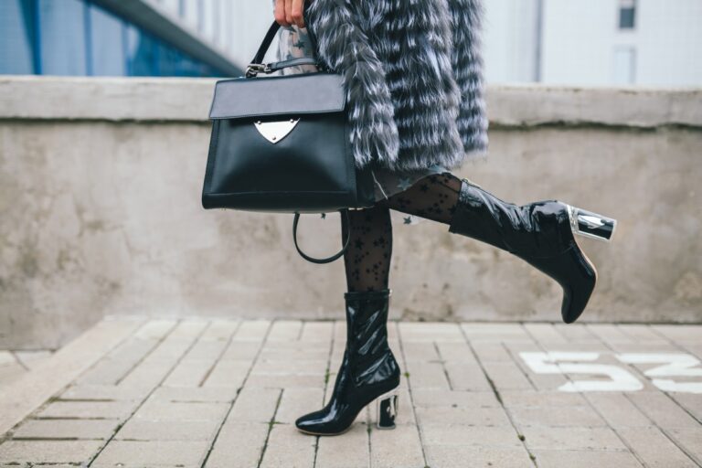 close up accessories details stylish woman walking city warm fur coat winter season cold weather holding leather handbag legs boots footwear street fashion trend 1.jpg