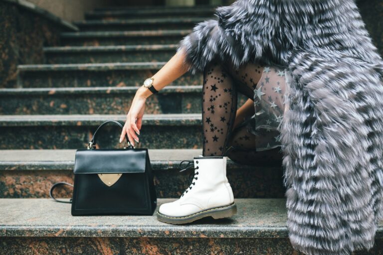 close up legs white boots fashionable woman posing city warm fur coat with black leather bag 1.jpg