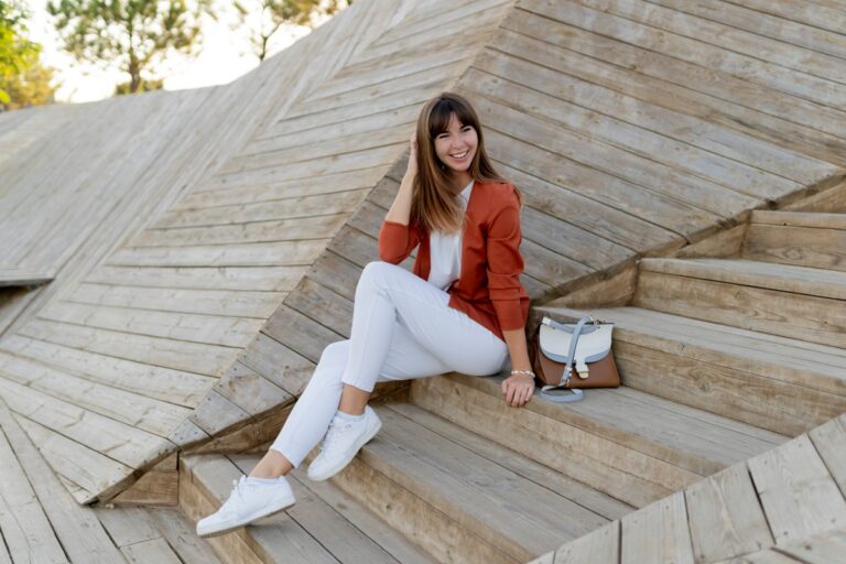 happy stylish female student posing modern park wesring white jeans jacket t shirt 1.jpg