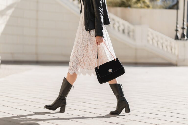 young pretty woman walking street fashionable outfit holding purse wearing black leather jacket white lace dress spring autumn style warm sunny weather romantic look 1.jpg
